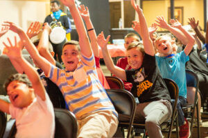 Children raising their hands having fun